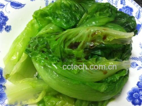 一道刚出锅的清炒生菜与娃娃菜被盛放在白色瓷盘中,菜品色泽碧绿鲜亮,蒜片分布均匀,表面略带光泽但无多余汤汁,旁边配有木筷和一碗米饭,整体呈现温馨家常风格 成品装盘的生菜和娃娃菜一起炒