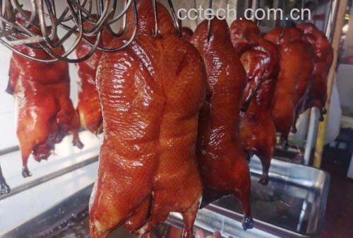 砂锅中正在炖煮的老姜炖鸭,汤汁已呈金黄色,鸭肉和姜片清晰可见,热气腾腾 老姜炖鸭炖煮过程图