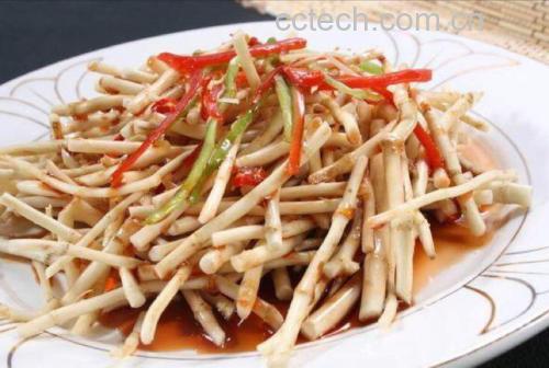 一盘精致的凉拌鱼腥草根,颜色呈乳白色至浅黄色,配有红椒丝点缀,淋有少量酱汁,摆盘清新自然,旁边放有一双竹筷,背景为木质餐桌 凉拌鱼腥草根菜品图
