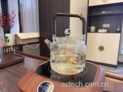 小金桔与普洱茶在玻璃壶中小火熬煮场景